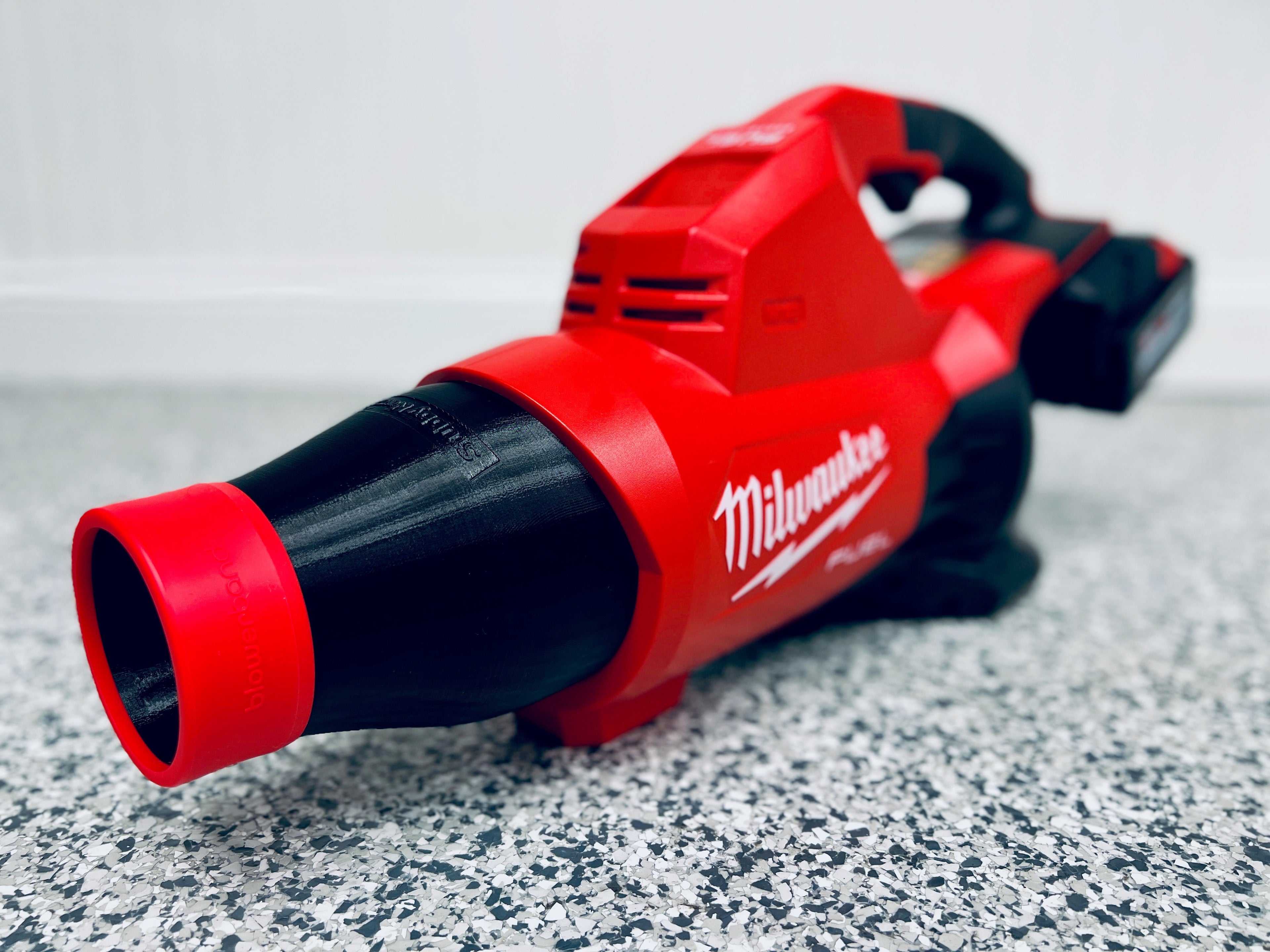 A close-up of the STUBBY® Car Drying Nozzle, designed for the Milwaukee M18 FUEL Dual Battery Leaf Blower (2824-20), resting on a speckled grey floor—a must-have car drying accessory for auto enthusiasts.