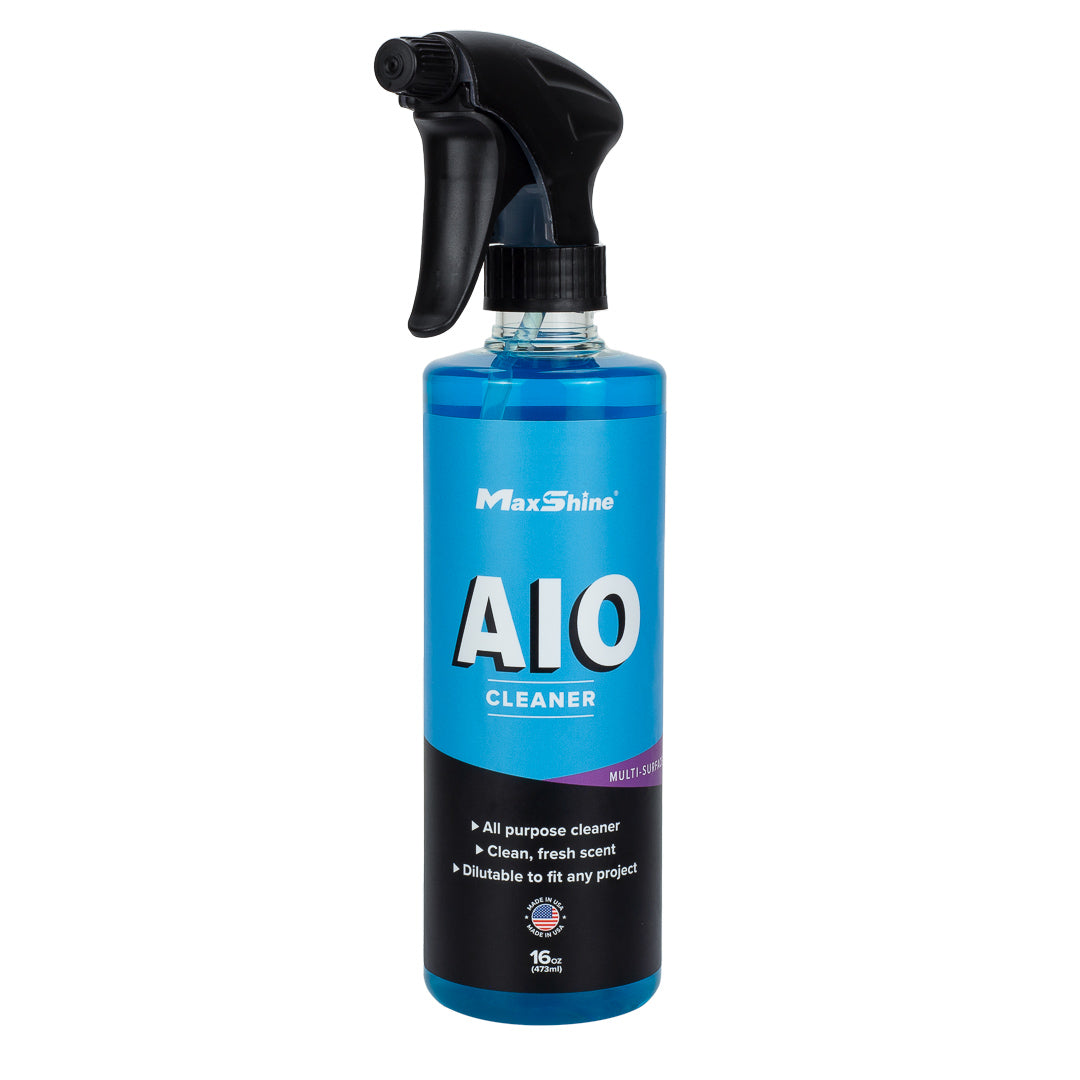 A blue spray bottle labeled MaxShine Interior Car Cleaner | AIO Cleaner (16oz, 1gal) with a black trigger nozzle offers a clean, fresh scent and is ideal for car detailing or interior cleaning projects.