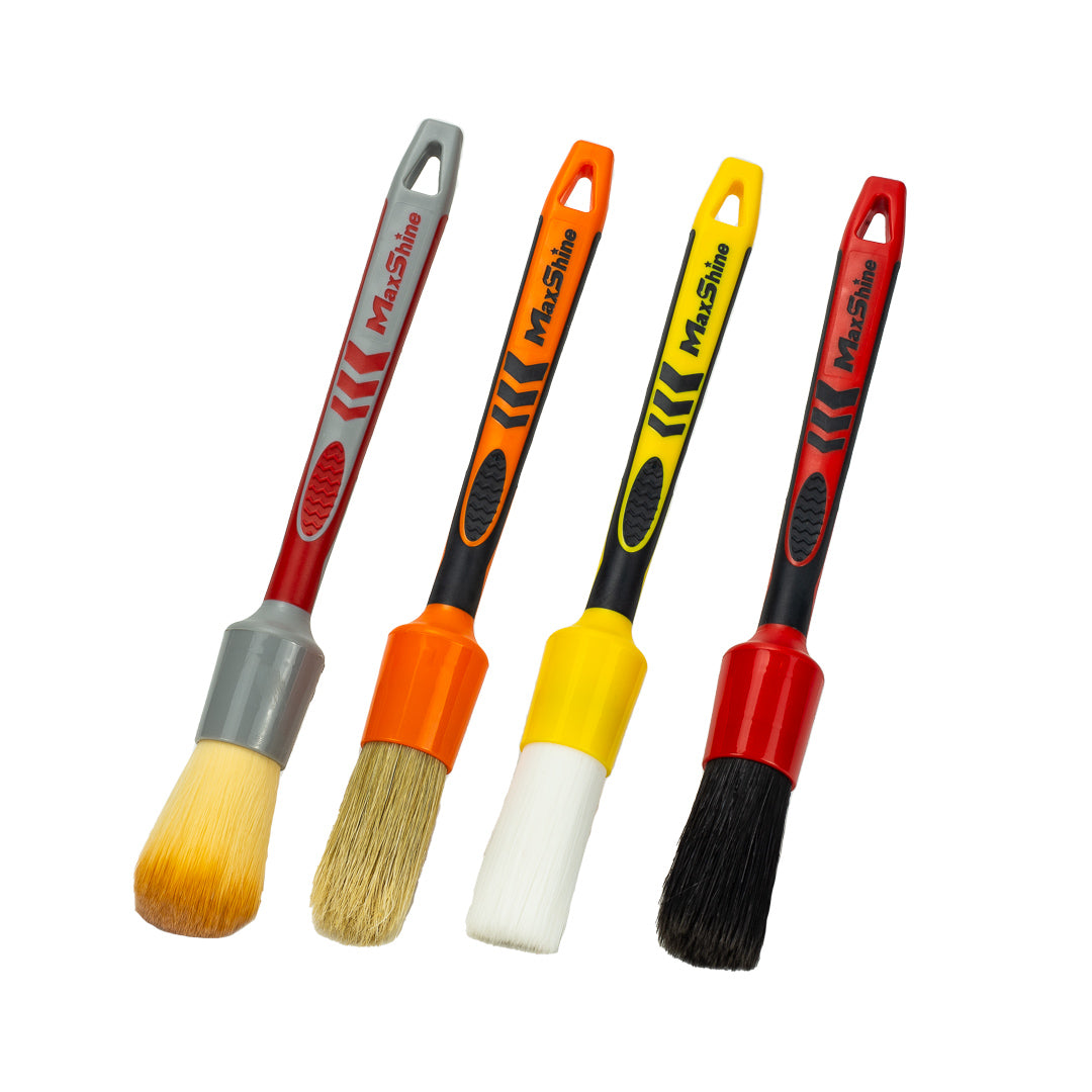The Detailing Brush Kits include four ergonomic brushes with colored bristles and ferrules—red, gray, orange, yellow, black—and soft boar’s hair for car cleaning, all arranged side by side on a white background.