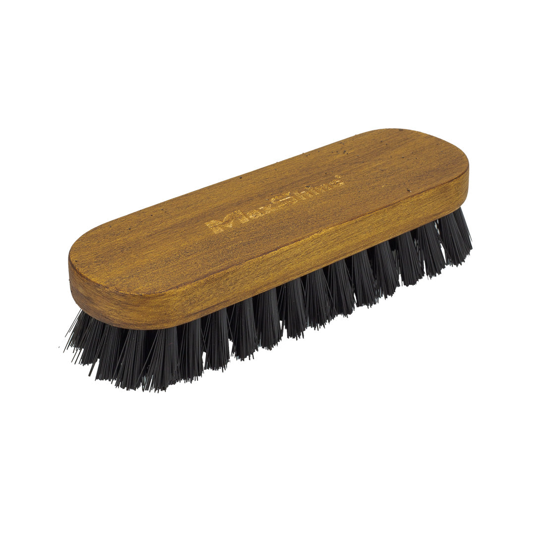 The Compact Leather Cleaning Brush, shown on a white background, features a wooden handle with an easy grip and smooth finish, soft nylon bristles, and the brand name engraved on top.