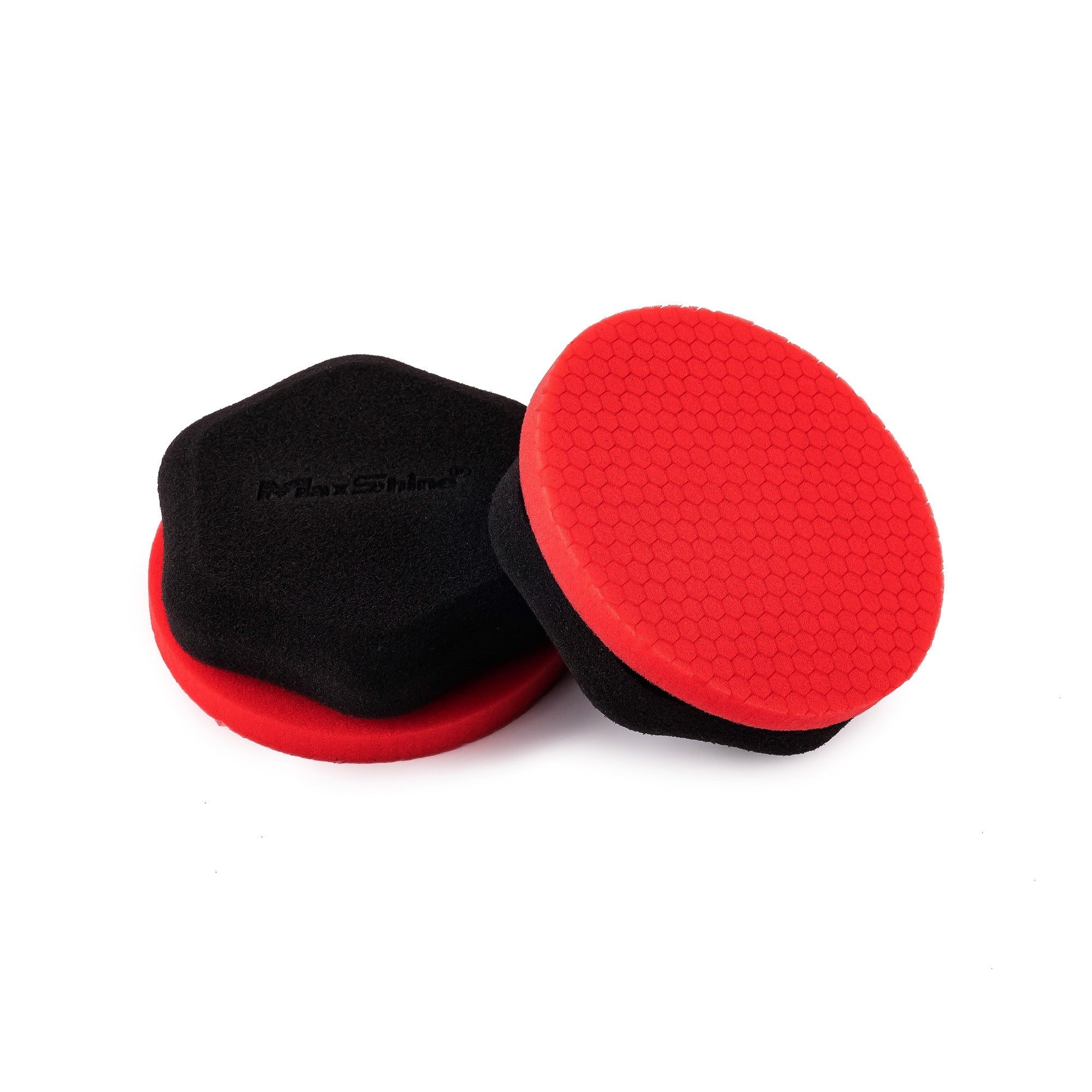 The Honeycomb Foam Precision Wax Applicator – 2 Pack features black foam pads with red textured surfaces, shown facing up and at an angle to highlight both top and side. Available in hexagonal and round shapes for precise waxing.