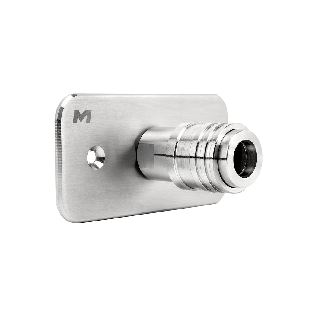 The Auto-Lock Quick Connect Foam Cannon Wall Mount features a cylindrical hose connector, quick connect, mounting hole, and an engraved M logo on its brushed metal surface—perfect for any detailing space.