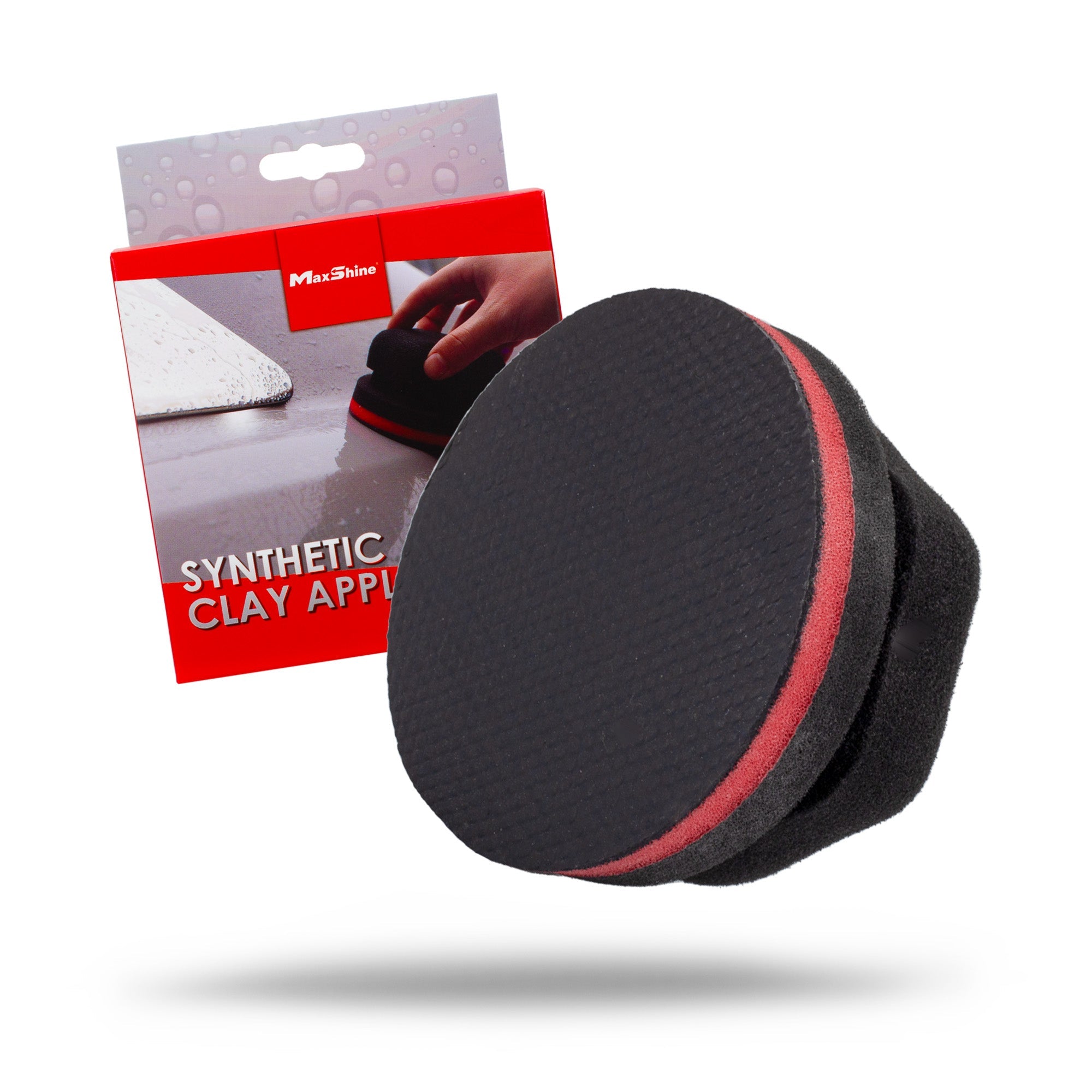 A Maxshine black and red Synthetic Clay Applicator is shown in front of its packaging, which features an image of a hand using this detailing tool on a white surface. The packaging reads "Synthetic Clay App.